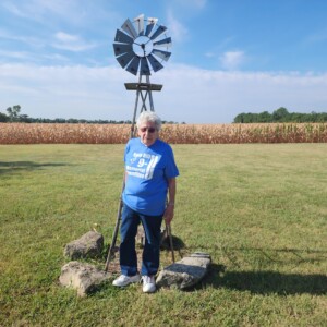 Linot poses in front of the windmill that graces her 150-acre estate.
